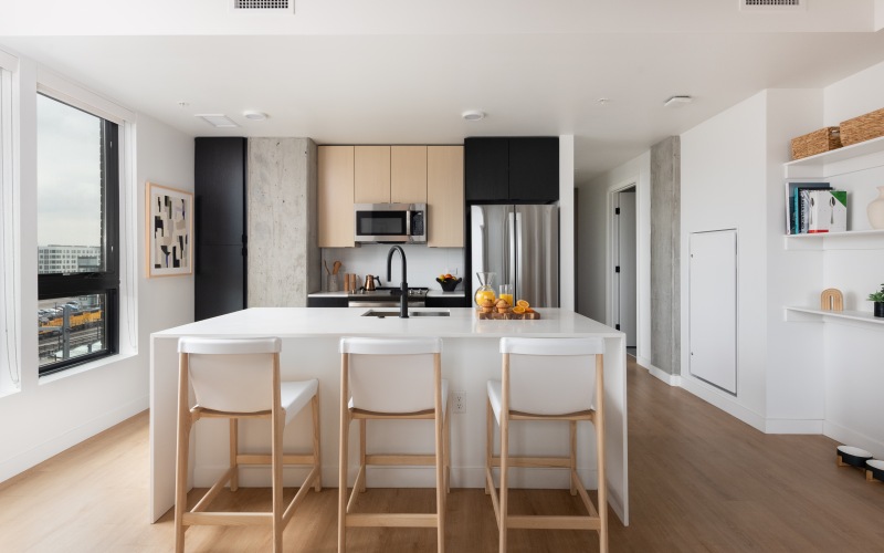 an apartment kitchen with island and bar top seating