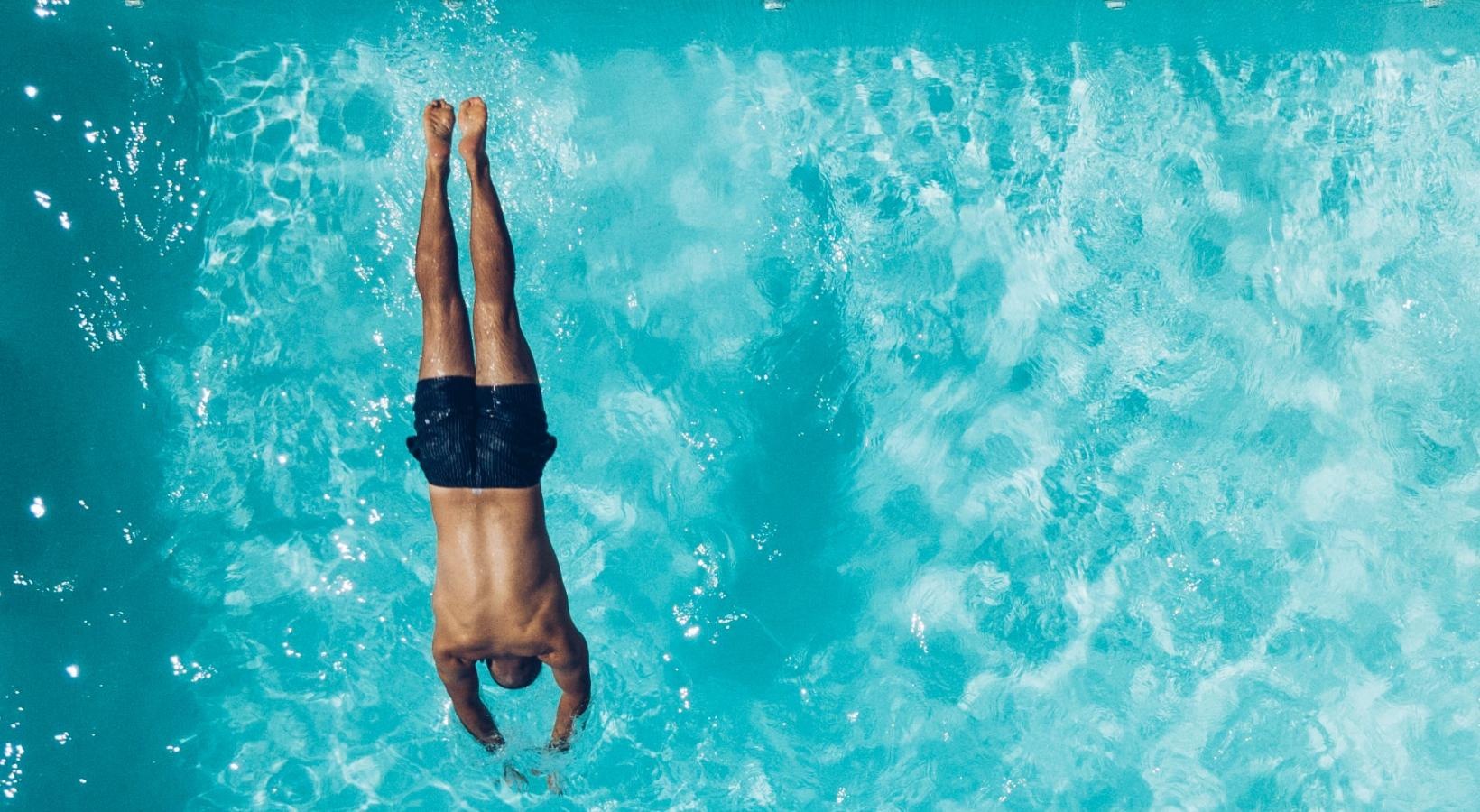 Resort-style swimming pool a person swimming in a pool