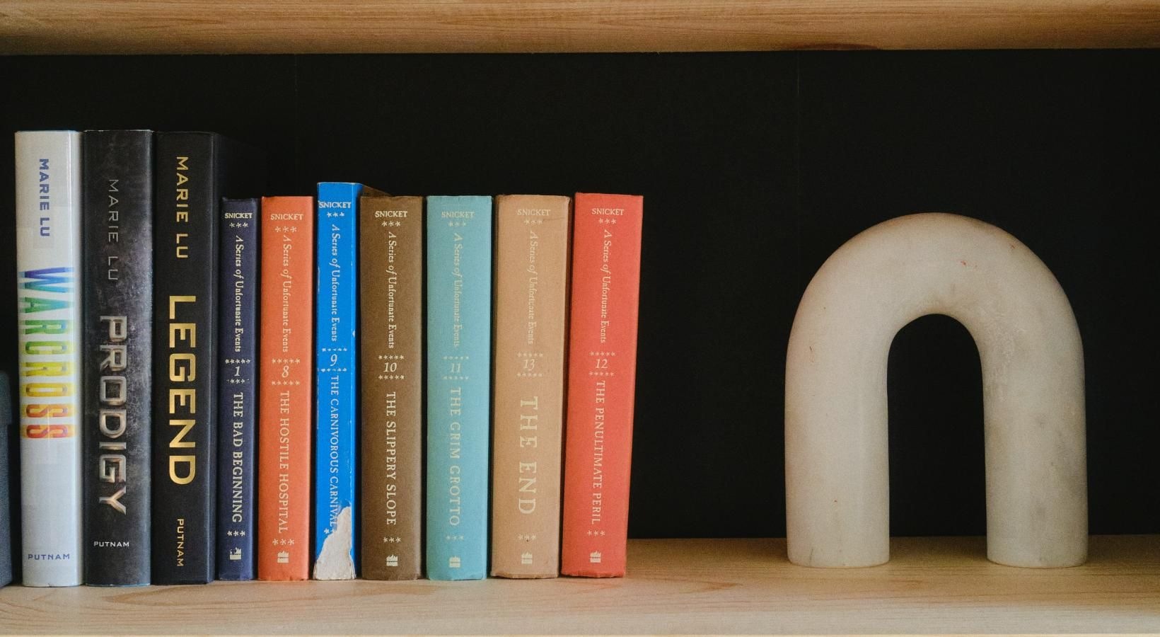 Settle into comfort at FoundryLine a shelf with books and a plant