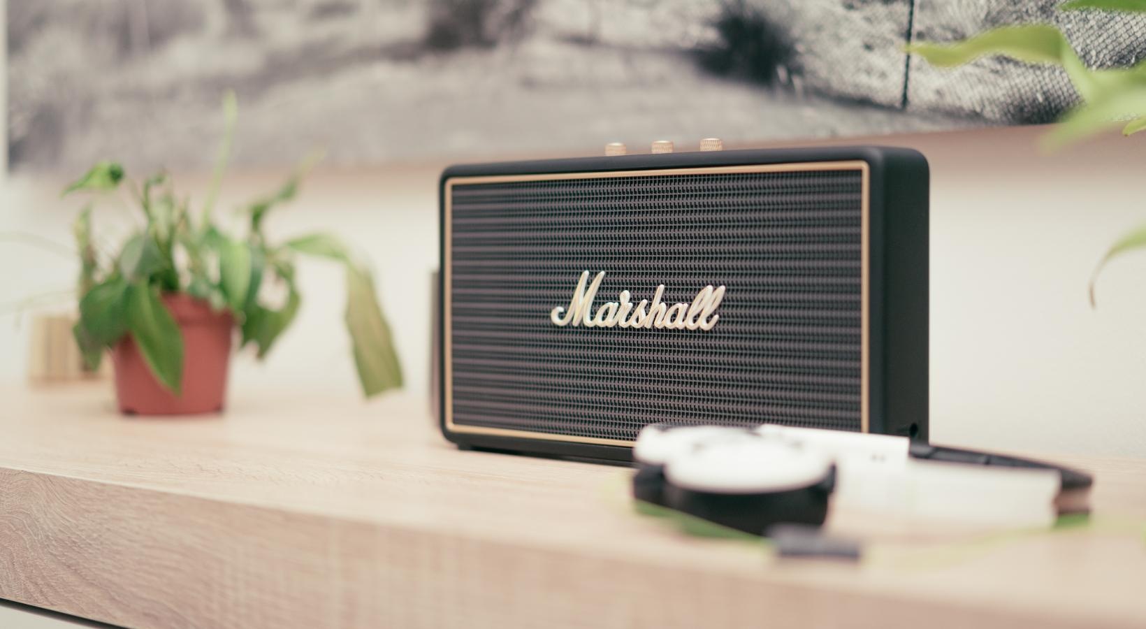 The essence of exceptional living a black box with a logo on it next to a plant